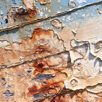 Boards of old boat with peeling paint background texture