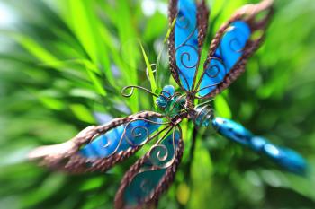 Artificial decorative butterfly in a plant, creative blur effect