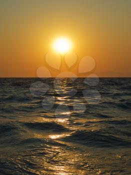 Aegean sea sunset with sun track on water surface. Rhodes island. Greece.