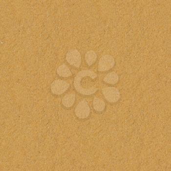Seamless yellow sand flat surface texture.
