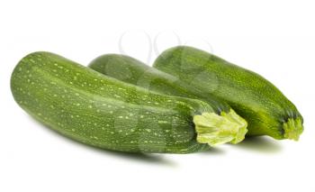 Three fresh green zucchini isolated on white background