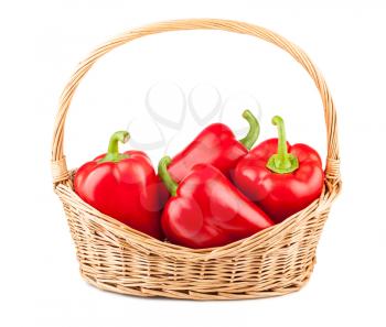 Sweet red pepper in a wicker basket isolated on white background