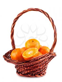 Ripe tangerine in brown basket isolated on white background
