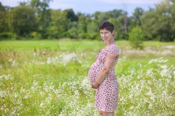 Royalty Free Photo of a Pregnant Woman in a Meadow