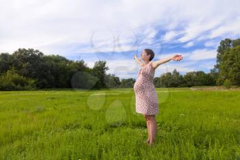 Royalty Free Photo of a Pregnant Woman in a Field