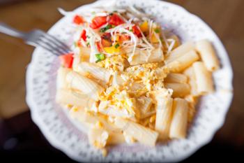 Pasta with salad from tomato and cabbage, selective focus
