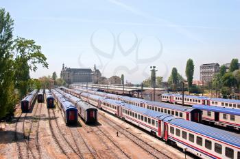 Railway station with wagons and tracks in sunny day
