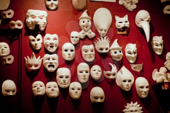 White Venice masks on the red wall
