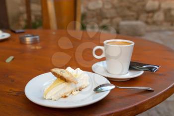 Lemon cake with hazelnut cookie and cup of coffee
