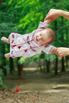 Baby in ukrainian folk dress vyshyvanka in father's hands
