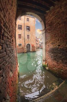 Tunnel to the channel with stairs and bridges in Venice, Italy
