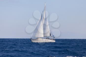Sailing boat in open blue sea
