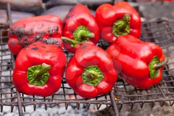 Red grilled pepper on bbq fireplace
