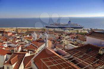 Lisbon roofs and cruise ship in harbor, top view
