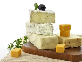 Royalty Free Photo of an Assortment of Cheese On a Cutting Board
