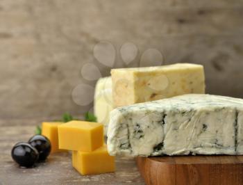 Royalty Free Photo of an Assortment of Cheese On a Cutting Board