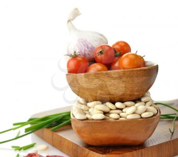 Royalty Free Photo of Baby Lima Beans, Tomatoes And Spices In Wooden Bowls