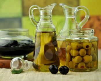  bottles of olive oil with black and green olives
