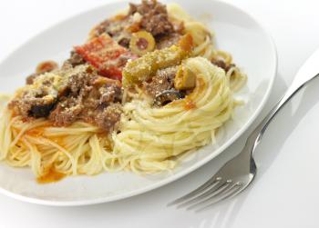 pasta nests with meat and vegetables in a white plate