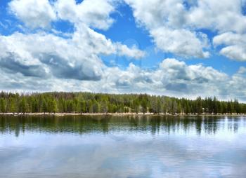 landscape with big lake with forest in high mountains  and beautiful sky