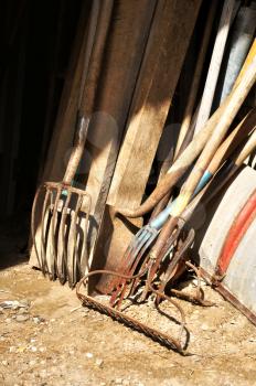 Gardening tools and wood stored in the barn
