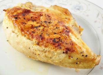 a Grilled chicken breast on a plate , close up