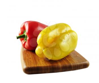red and yellow sweet peper on a cutting board