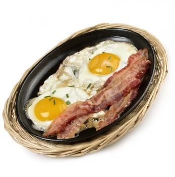 Fried Eggs And Bacon  In A Skillet 