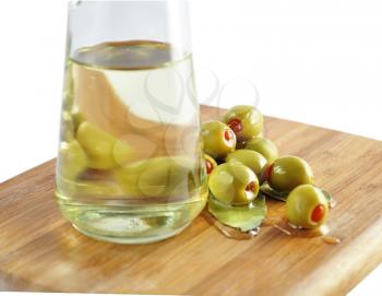green olives and cooking oil , close up