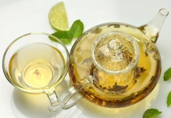 green tea composition with teapot,cup ,lime and peppermint 
