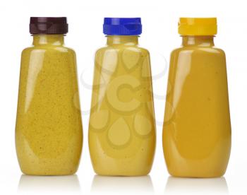 plastic  bottles of honey ,dijon and spicy brown mustard