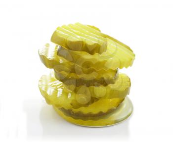 a stack of pickle slices on white background