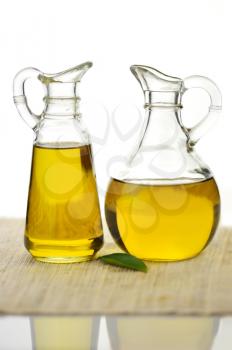 two bottles of olive oil on white background