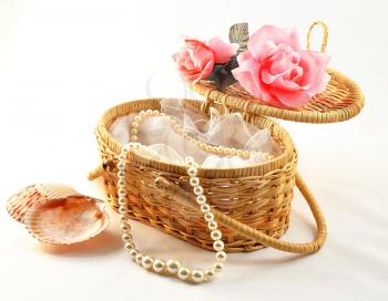 decorative basket with pearl  on white background