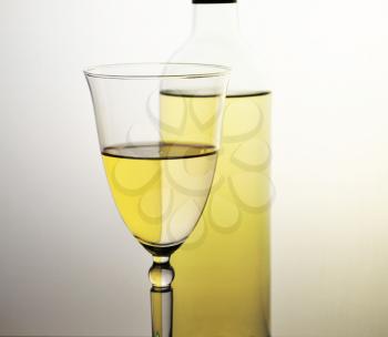a glass of white wine and a bottle