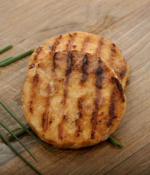 Salmon Burgers On A Wooden Board