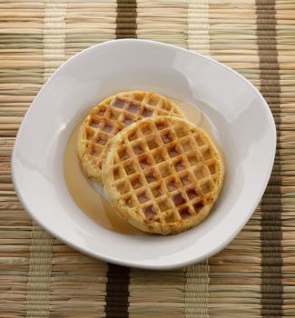 Waffles With  Maple Syrup In A White Plate