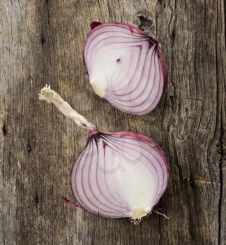 Royalty Free Photo of a Sliced Onion on Wood