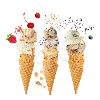 Variety of ice cream scoops in cones with chocolate, vanilla and strawberry isolated on white background