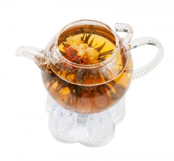 Exotic green tea with flowers in glass teapot isolated on white 