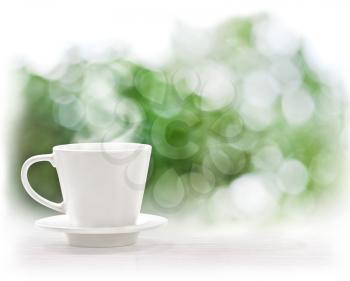 Cup of hot drink on defocus summer background