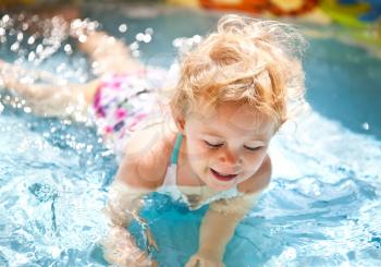 Little blondie girl in the swimming pool