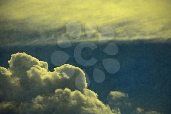 Retro style cloudscape with vintage colors and a textured paper background. 