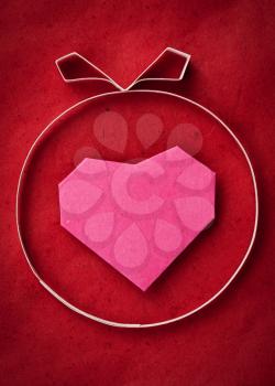 Hand made paper heart on red kraft paper as background. Greeting card