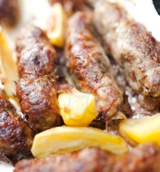 Grilled sausage served with potato