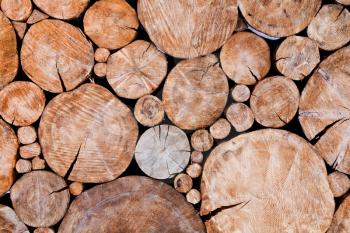 Stacked logs, wooden background