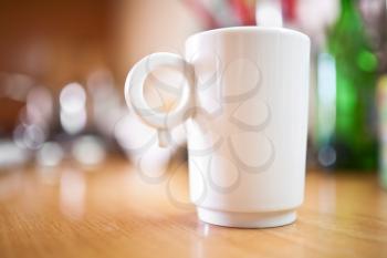 Cup of coffee or tea on wooden table, small dof