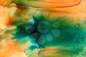 Abstract green orange smooth with texture.Colorful background hand drawn with bright inks and watercolor paints. Color splashes and splatters create uneven artistic modern design.