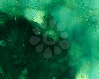 Deep green smooth cloudy texture.Colorful background hand drawn with bright inks and watercolor paints. Color splashes and splatters create uneven artistic modern design.