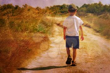 Vintage picture of a young child walking on a road